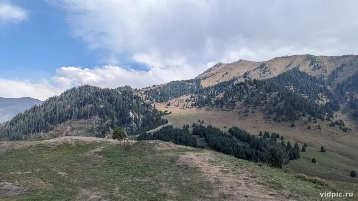 Landscape with green mountains and cloudy sky. Perfect for inspiration and relaxation.