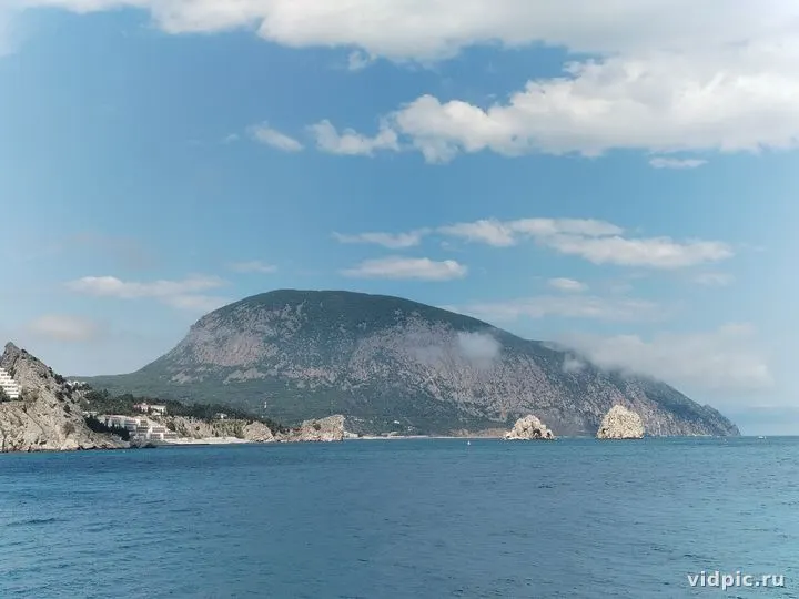 A sea cliff with a view of the village. Perfect for illustrating landscapes, nature, and travel.