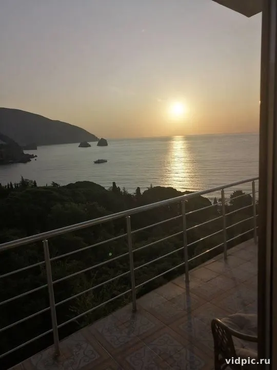 Sunset over the sea with a view of islands. The sunset paints the sea with golden hues.