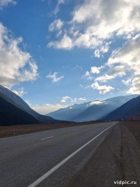 Empty mountain road stretching into the distance. Perfect for travel and car advertisements.