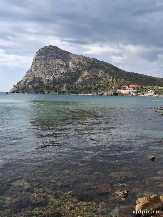 A high sea cliff with a view of a small village. Suitable for illustrating travel stories and sea holidays.